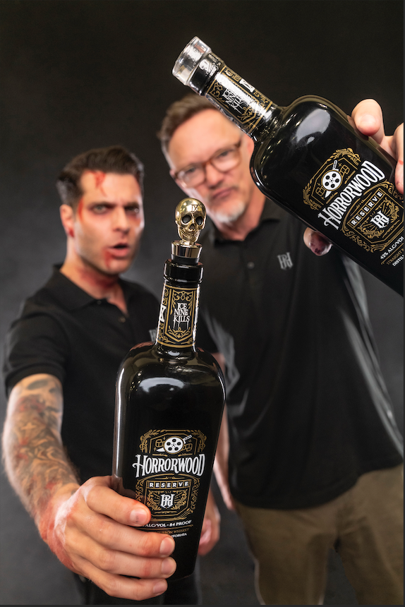 Spencer and Matthew holding up two Horrorwood Reserve bottles to the camera