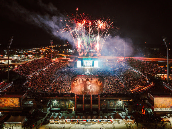 View of Sonic Temple, a large crowd is filling the arena and fireworks are lit.