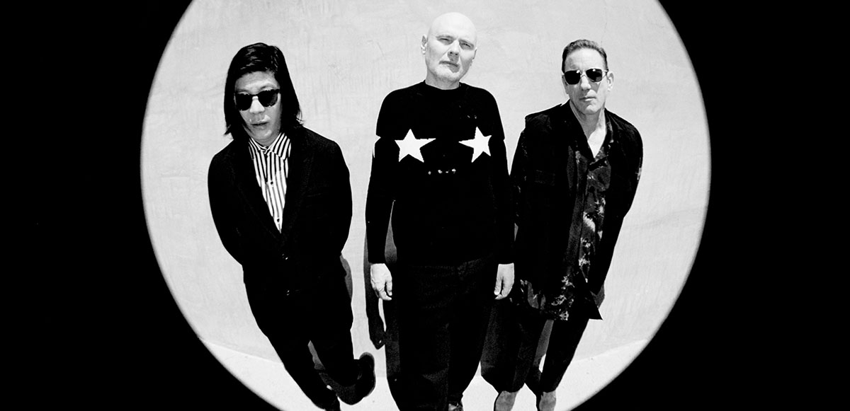 The Smashing Pumpkins members standing together in a black and white fisheye lens photo