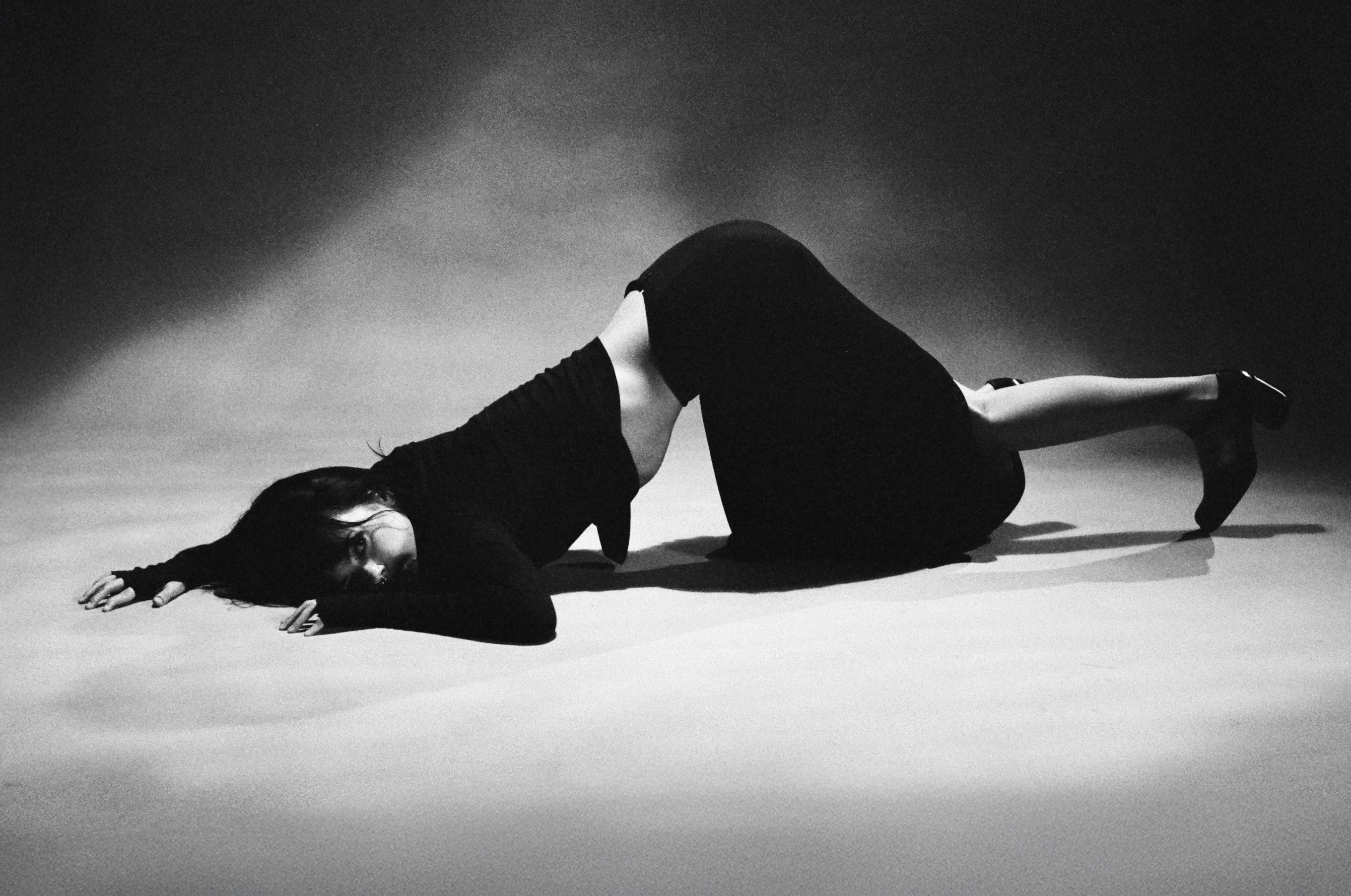 Black and white photo of Delaney Bailey laying face down.
