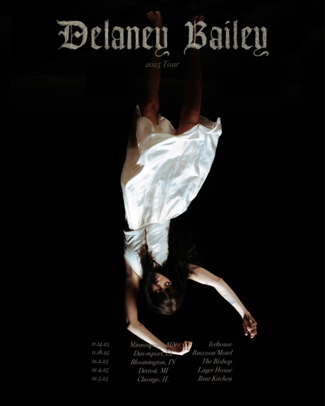 Delaney Bailey hanging upside-down in a white dress