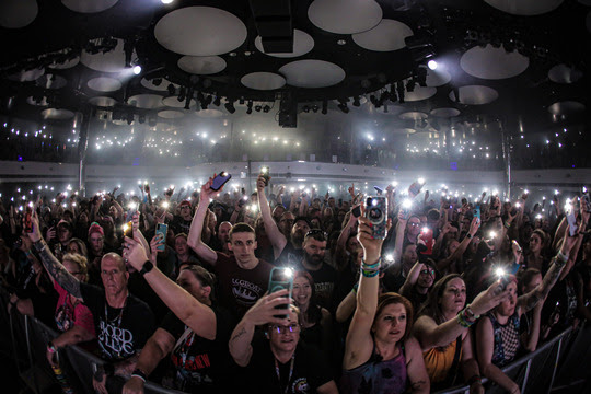 Fans at From Ashes To New’s theater show holding up lights from their phones