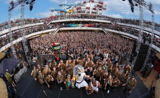 The greek mythology mascot of ShipRocked kneeling with fans on the desk.